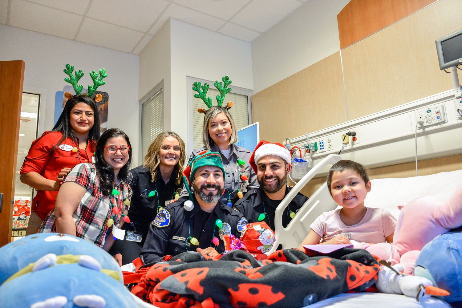 Participants and a child smiling in a hospital room